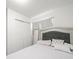 Bedroom featuring a large closet, a grey headboard, and a large mirror on light wood floors at 8233 44Th St N N St, Pinellas Park, FL 33781