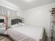 Bedroom featuring a grey-toned bed frame and headboard, plus light wood floors and large mirror at 8233 44Th St N N St, Pinellas Park, FL 33781