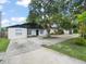 Charming single-story home with a large tree in the front yard at 8233 44Th St N N St, Pinellas Park, FL 33781
