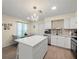 Bright kitchen features stainless steel appliances, white cabinetry, mosaic backsplash, eat-in dining, and a large island at 8233 44Th St N N St, Pinellas Park, FL 33781