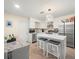 Bright kitchen features stainless steel appliances, white cabinetry, mosaic backsplash, and a large quartz island at 8233 44Th St N N St, Pinellas Park, FL 33781