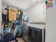 Laundry room featuring a washer and dryer, storage space, and tiled walls at 8233 44Th St N N St, Pinellas Park, FL 33781