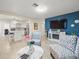 Bright living room featuring wood floors, blue accent wall, and modern furnishings at 8233 44Th St N N St, Pinellas Park, FL 33781