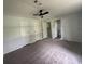 Bedroom with carpet, ceiling fan, three closets and bathroom view at 9053 Bourbon St, New Port Richey, FL 34654