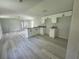 Bright, open kitchen with white cabinets, granite countertops and stainless steel faucet at 9053 Bourbon St, New Port Richey, FL 34654