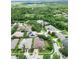 Aerial view of home surrounded by lush landscaping and nearby lakes at 10675 Park Place Dr, Largo, FL 33778