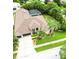 Overhead view showing the home's layout, screened in pool, and luscious yard at 10675 Park Place Dr, Largo, FL 33778