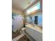 Bright bathroom with pineapple-themed shower curtain, neutral countertops, and a modern vanity at 10675 Park Place Dr, Largo, FL 33778