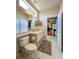 Well-lit bathroom featuring a sink, vanity, neutral tile, and a window for natural light at 10675 Park Place Dr, Largo, FL 33778