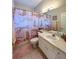 Charming bathroom with a unique cheetah print shower curtain, neutral countertops, and modern fixtures at 10675 Park Place Dr, Largo, FL 33778