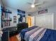 Comfortable bedroom with Tampa Bay Rays decor, a ceiling fan, hardwood floors, and plenty of storage at 10675 Park Place Dr, Largo, FL 33778