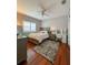 Cozy bedroom with wood floors, a ceiling fan, and a vanity area provides a relaxing space at 10675 Park Place Dr, Largo, FL 33778