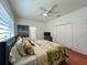 A primary bedroom with a bed, ceiling fan, and large closet offers a relaxing retreat at 10675 Park Place Dr, Largo, FL 33778