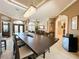 Elegant dining room featuring modern chandelier, neutral color scheme, and archway to the living room at 10675 Park Place Dr, Largo, FL 33778