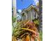 Exterior side view of house showcasing the decorative garden and arched window at 10675 Park Place Dr, Largo, FL 33778
