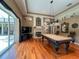 Game room with a pool table, fireplace, hardwood floors, and access to an outdoor patio at 10675 Park Place Dr, Largo, FL 33778