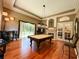 Entertaining game room features a pool table, fireplace, hardwood floors, and access to outdoor area at 10675 Park Place Dr, Largo, FL 33778