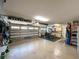 Spacious two-car garage with ample storage, work bench, and natural light from windows at 10675 Park Place Dr, Largo, FL 33778