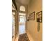 Hallway with tile floors and access to the main bathroom at 10675 Park Place Dr, Largo, FL 33778