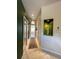 Hallway with tile floors and access to the main bathroom and walk-in closets at 10675 Park Place Dr, Largo, FL 33778