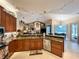 Spacious open kitchen with granite countertops, stainless steel appliances, and track lighting overlooking the living area at 10675 Park Place Dr, Largo, FL 33778