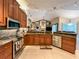 Spacious kitchen with stainless appliances, granite countertops, and tile backsplash at 10675 Park Place Dr, Largo, FL 33778
