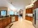 Well-lit kitchen with stainless steel appliances, tile backsplash, and granite countertops at 10675 Park Place Dr, Largo, FL 33778