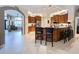 Kitchen with wood cabinets, granite countertops, and tile floors at 10675 Park Place Dr, Largo, FL 33778