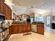 Kitchen with granite countertops, wood cabinets, and open to the Gathering room at 10675 Park Place Dr, Largo, FL 33778