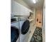Well-equipped laundry room features modern washer and dryer set, utility sink, and ample storage at 10675 Park Place Dr, Largo, FL 33778