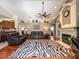 Inviting living room with hardwood floors, fireplace, and comfortable seating arrangement, perfect for gatherings at 10675 Park Place Dr, Largo, FL 33778