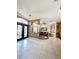 Open-concept living room with tile floors, a sofa and dark wood trim at 10675 Park Place Dr, Largo, FL 33778