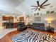 Open living room showcasing stylish zebra rug, hardwood floors, and access to a modern kitchen at 10675 Park Place Dr, Largo, FL 33778