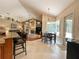 Open concept living space featuring a fireplace, large windows, and seamless flow into dining area at 10675 Park Place Dr, Largo, FL 33778