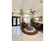 Living room with sofa, side chair, tile floors and a large ceiling fan at 10675 Park Place Dr, Largo, FL 33778