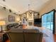 Inviting living room with vaulted ceilings, a cozy fireplace, and sliding glass doors to the pool area at 10675 Park Place Dr, Largo, FL 33778