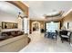 Open-concept living and dining area featuring tile floors and neutral tones at 10675 Park Place Dr, Largo, FL 33778