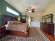 Main bedroom with a large area rug, wood floors, and a ceiling fan at 10675 Park Place Dr, Largo, FL 33778