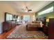 Spacious main bedroom with a ceiling fan, wood floors, and access to a balcony at 10675 Park Place Dr, Largo, FL 33778