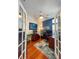 Home office with hardwood floors, French doors, and a stylish blue accent wall at 10675 Park Place Dr, Largo, FL 33778