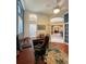 Bright office with hardwood floors, plantation shutters, and an open doorway to the living and dining rooms at 10675 Park Place Dr, Largo, FL 33778
