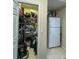 Pantry area with full shelving, and refrigerator, offers convenient storage at 10675 Park Place Dr, Largo, FL 33778