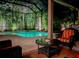 Inviting screened-in patio offers a luxurious pool and comfortable outdoor seating for relaxation and entertainment at 10675 Park Place Dr, Largo, FL 33778