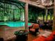 Inviting screened-in patio offers a luxurious pool and comfortable outdoor seating for relaxation and entertainment at 10675 Park Place Dr, Largo, FL 33778