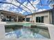 Aerial view of backyard pool and jacuzzi, surrounded by a patio and the home's outdoor living spaces at 10675 Park Place Dr, Largo, FL 33778