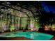 Captivating pool area enclosed in a screen, surrounded by verdant tropical foliage at 10675 Park Place Dr, Largo, FL 33778
