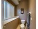 Powder room with a toilet and a small window at 10675 Park Place Dr, Largo, FL 33778