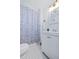 Cozy bathroom showcasing a tiled tub-shower, white vanity, and decorative mirror, offering a functional space at 112 E Plymouth St, Tampa, FL 33603