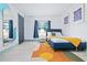 Stylish bedroom with a modern bed, unique mirror and blue-themed decor at 112 E Plymouth St, Tampa, FL 33603
