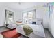 Comfortable bedroom with two twin beds, colorful accents, and lots of natural light at 112 E Plymouth St, Tampa, FL 33603